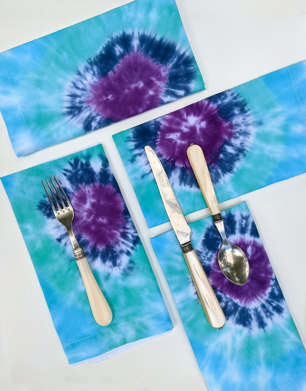 DIY tie-dye cloth napkins in indigo, turquoise blue, and purple