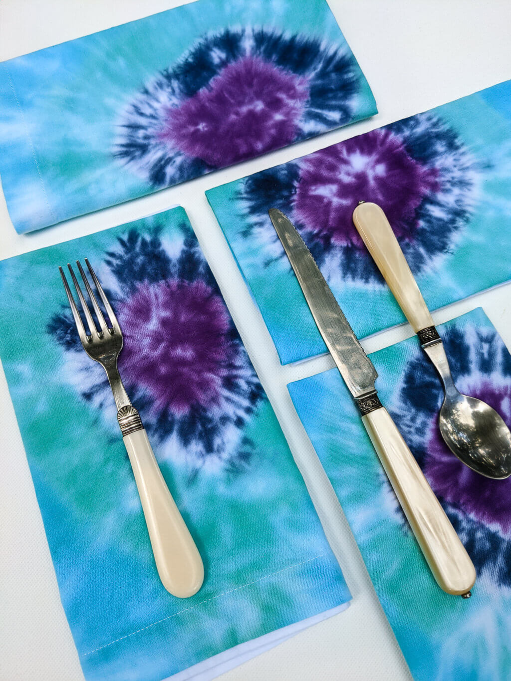 DIY tie-dye cloth napkins in indigo, turquoise blue, and purple