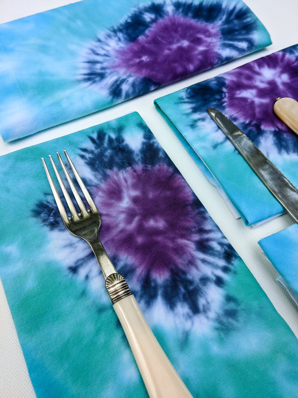 DIY tie-dye cloth napkins in indigo, turquoise blue, and purple