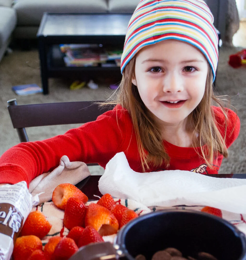 Elise making chocolate strawberries for Valentine's Day. Copyright Merriment Design Co. Do not use without written permission.