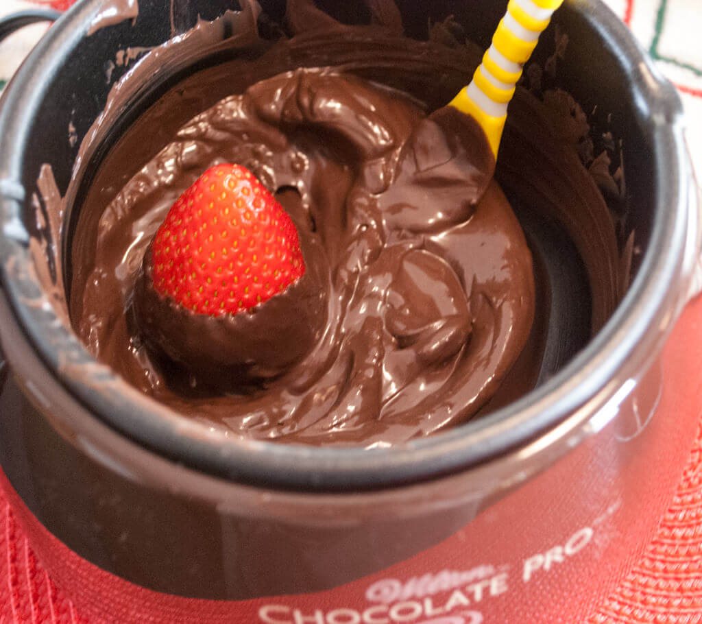 Dipping a strawberry in chocolate