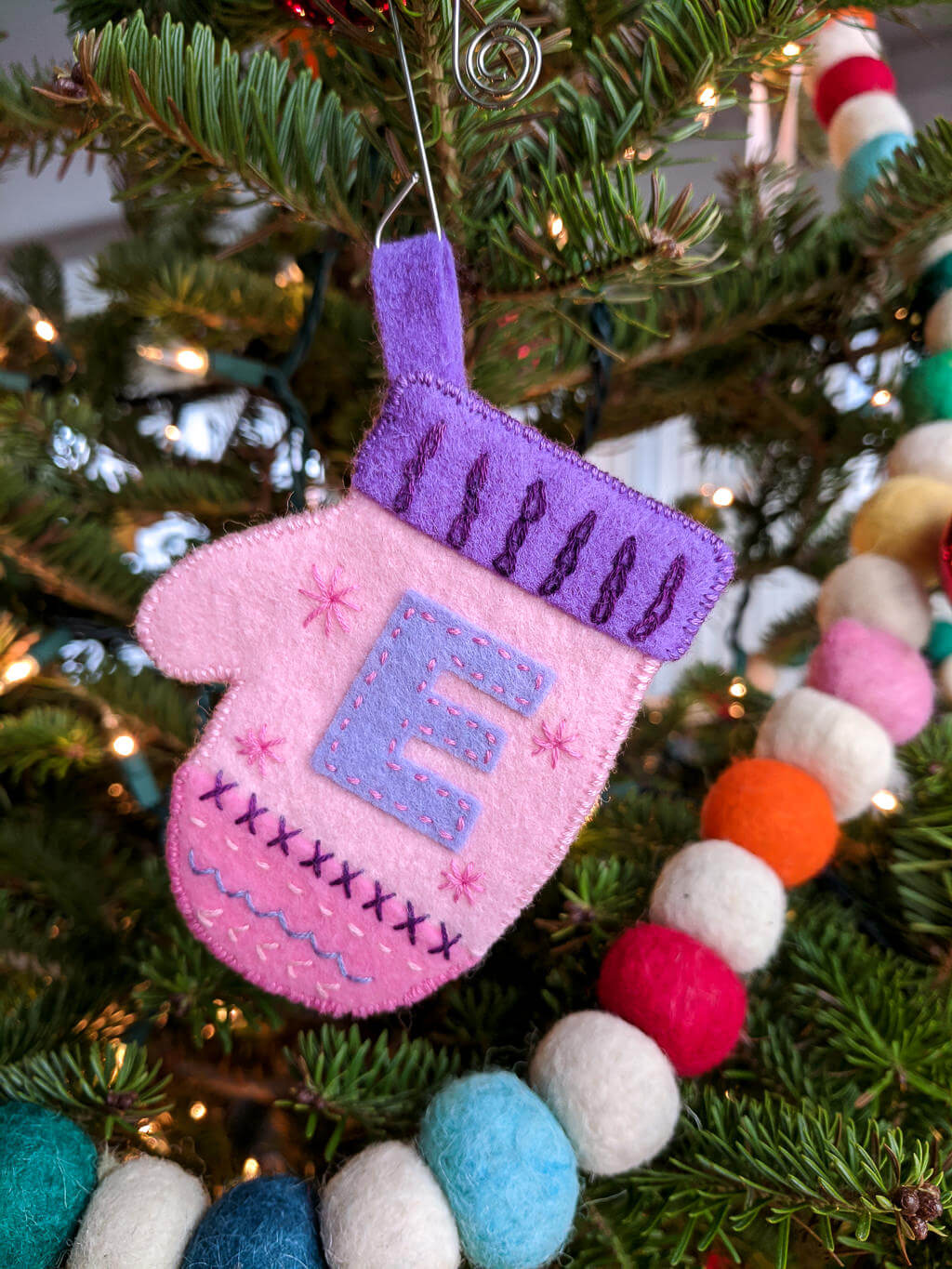 DIY monogrammed mitten ornament on a Christmas tree