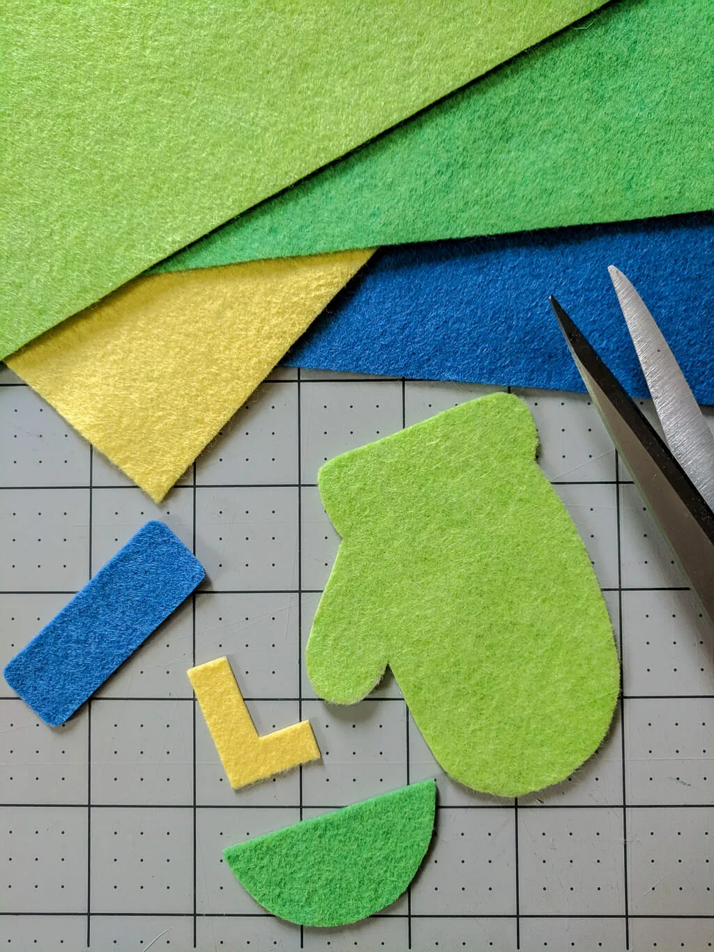 Cut pieces for making DIY wool felt mitten ornaments for Christmas